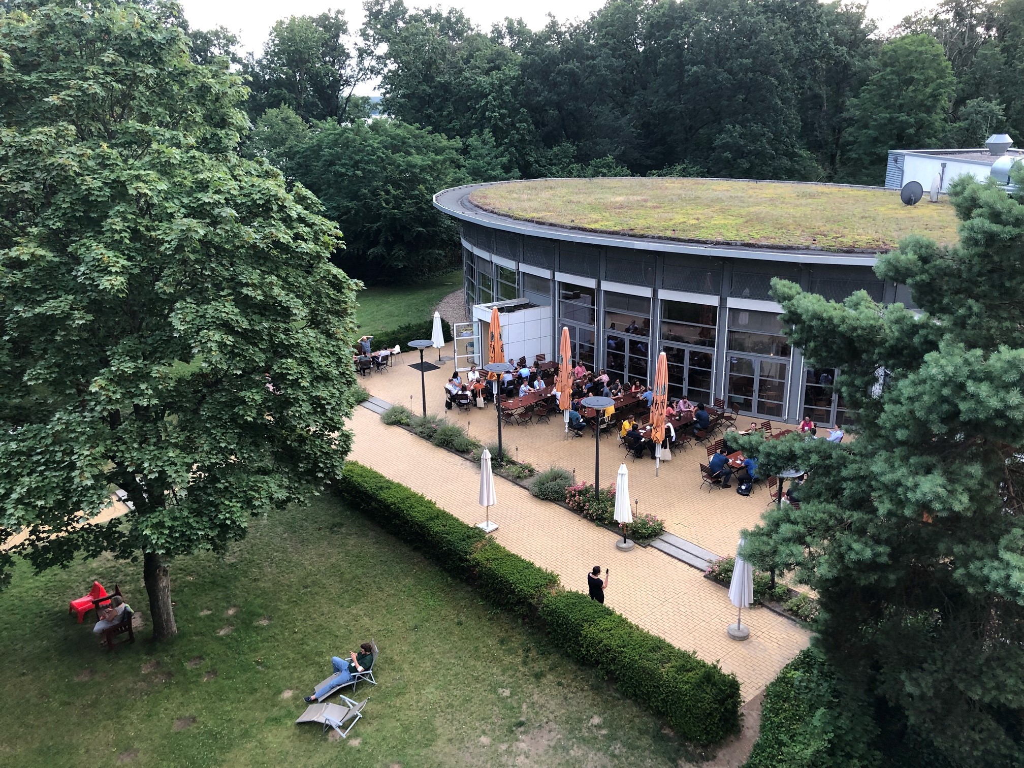 Blick von oben auf den Garten und die Terrasse des Hotels