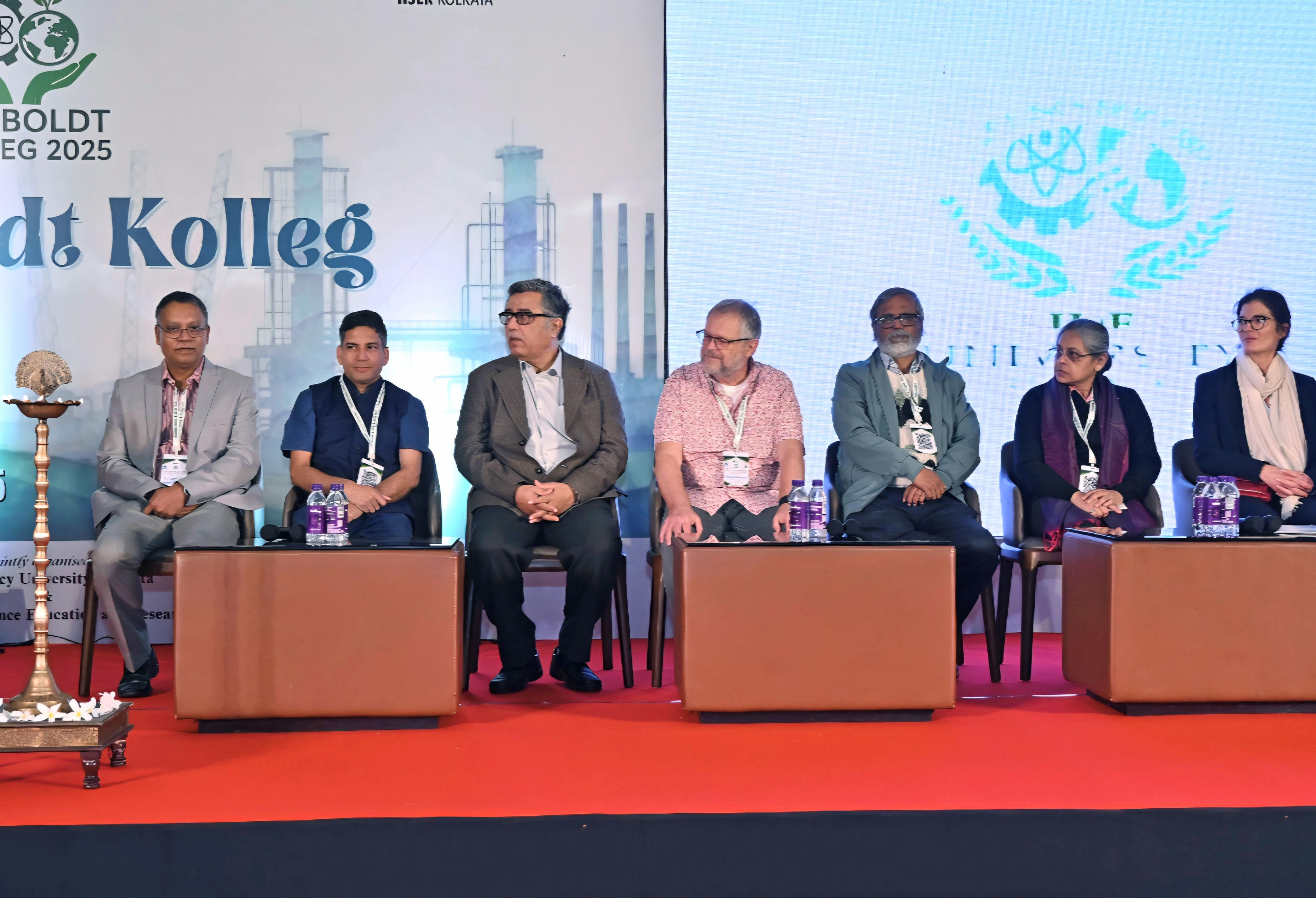 group picture at an Inaugural ceremony with the following attendees from left to right: Dr Malay Das, Convener of the Humboldt Kolleg, Kolkata; Prof. Debasish Haldar, IISER Kolkata; Prof. Nirmalya Narayan Chakraborty, Vice Chancellor, Presidency University; Prof. Jörg-Peter Schnitzler, Helmholtz Zentrum München - Deutsches Forschungszentrum für Gesundheit und Umwelt (GmbH), Neuherberg, Germany; Prof. Pulak Sengupta, Jadavpur University; Ms Susmita Mandal, Officer - Political Affairs, Culture, Press and Public Relations, Consulate General of the Federal Republic of Germany in Kolkata; Ms. Judith Koester, Programme Officer, Alexander von Humboldt Foundation, Germany