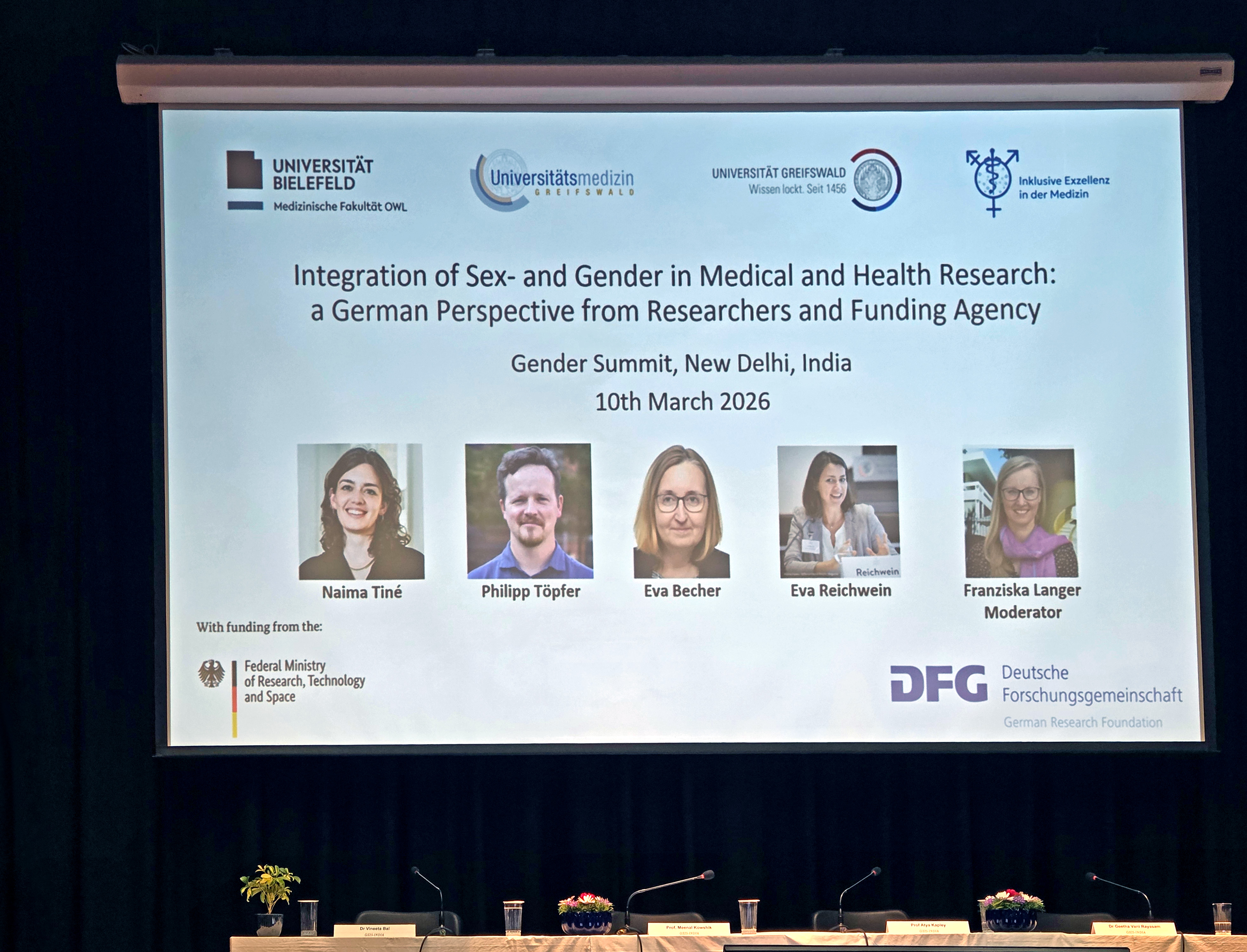picture of the video presentation of the DFG’s virtual plenary session titled “Integrating Sex- and Gender-Sensitive Perspectives into Medical and Health Research – a German Perspective” with the following speakers: Naima Tiné, University of Greifswald; Dr. Philipp Töpfer, University Medicine Greifswald; Dr. Eva Becher, Bielefeld University and Dr. Eva Reichwein, DFG Research Culture Group and Dr. Franziska Langer, Director, DFG India and DFG International Affairs. 