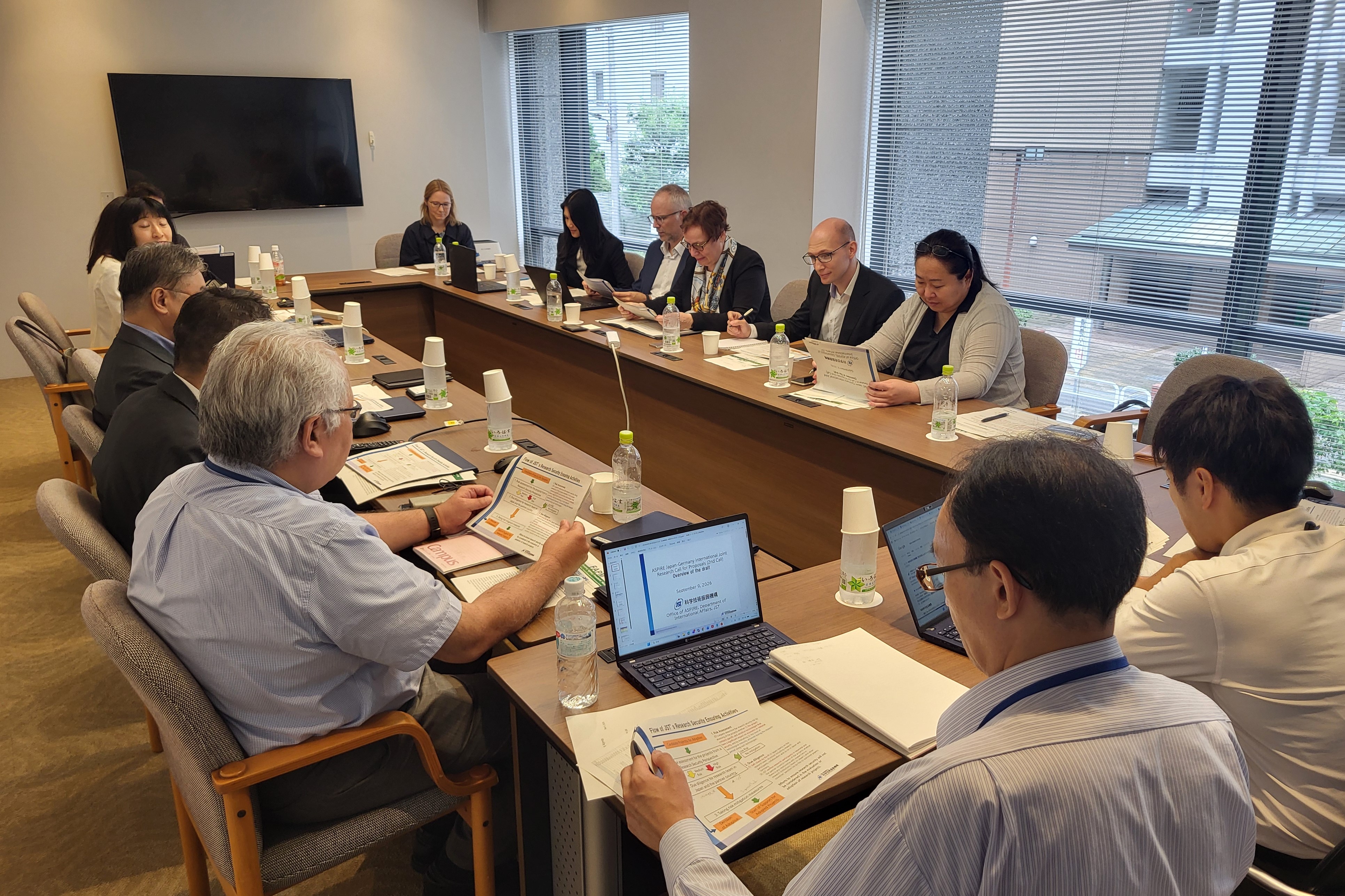 Picture of a conference room with attendees of the visit participating at a discussion with representatives of the Japan Science and Technology Agency (JST)
